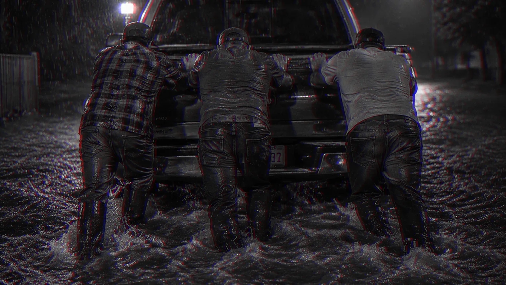 Men set their shoulders together against the same load.